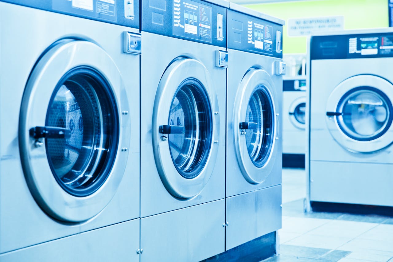Row of industrial washing machines in a contemporary laundromat.